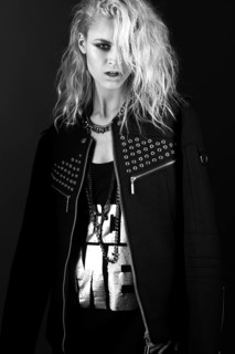 Daring girl model in black leather dress in the style of rock