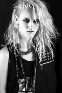 Daring girl model in black leather dress in the style of rock