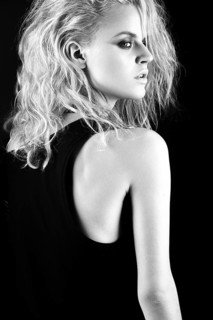 Daring girl model in black leather dress in the style of rock