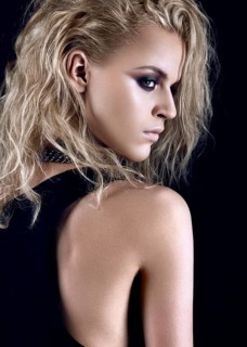 Daring girl model in black dress in the style of rock