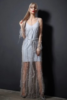 Beautiful girl in designer fashionable transparent clothes posing in studio. Beauty of face and body