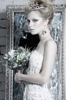 Beautiful girl in white dress in the image of the Snow Queen with a crown on her head. Picture taken in the studio with decorations