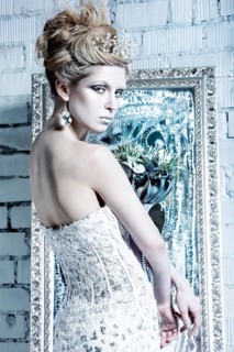 Beautiful girl in white dress in the image of the Snow Queen with a crown on her head. Picture taken in the studio with decorations