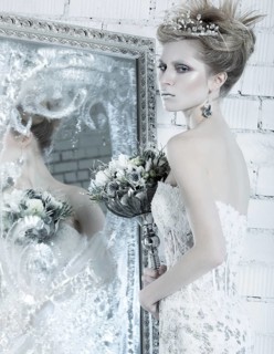 Beautiful girl in white dress in the image of the Snow Queen with a crown on her head. Picture taken in the studio with decorations