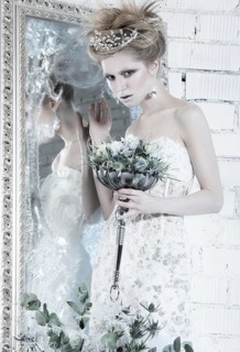 Beautiful girl in white dress in the image of the Snow Queen with a crown on her head. Picture taken in the studio with decorations
