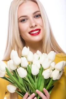 Portrait of beautiful fashion model with bouquet lily in hands
