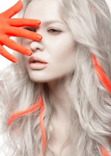 Art fashion girl with white skin in the form of albinos with red arms and a lock of hair. Creative image of beauty. Photos shot in studio