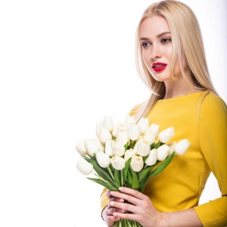 Portrait of beautiful fashion model with bouquet lily in hands