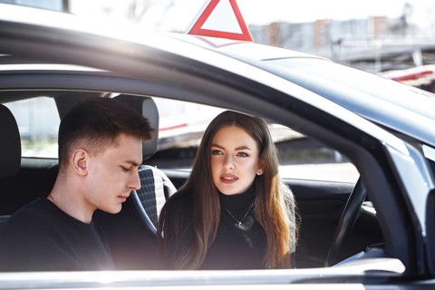 The driver is an auto school instructor and a female student on an examination car. Lesson at the circuit