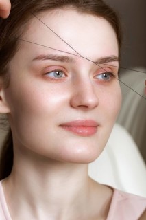 Permanent microblasting tattooing freckles to a woman in a beauty salon