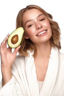 Beautiful tender young girl in a white coat with clean fresh skin posing in front of the camera. Beauty face. Skin care. Photo taken in studio on a white isolate background