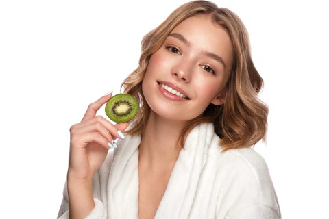 Beautiful tender young girl in a white coat with clean fresh skin posing in front of the camera. Beauty face. Skin care. Photo taken in studio on a white isolate background