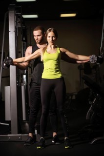 Sporty sexy man and woman with great abdominal muscles in black sportswear