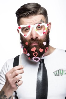 Funny bearded man with hearts Valentine's Day. Portrait shot in studio