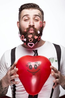 Funny bearded man with hearts Valentine's Day. Portrait shot in studio