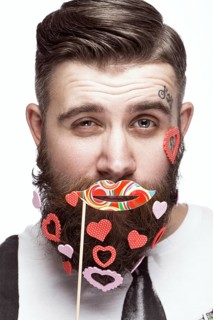 Funny bearded man with hearts Valentine's Day. Portrait shot in studio