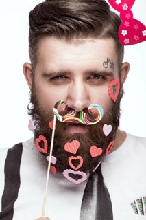 Funny bearded man with hearts Valentine's Day. Portrait shot in studio