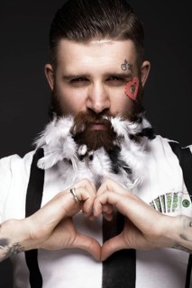 Funny bearded man with feathers and wings in the image of Cupid Valentine's Day. Portrait shot in studio