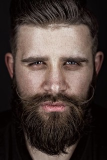 A solid man with a beard and mustache. Photos shot in the studio