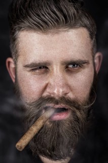 A solid man with a beard and mustache. Photos shot in the studio