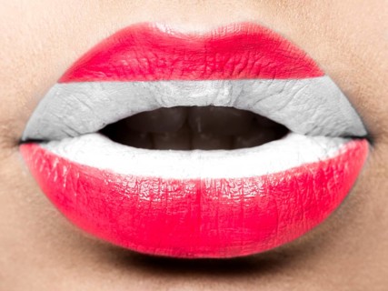 Female lips close up with a picture of the flag of Austria. white