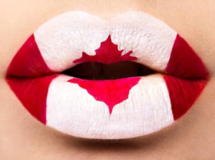 Female lips close up with a picture of the flag of Canada. Red