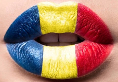 Female lips close up with a picture of the flag of Romania. Blue