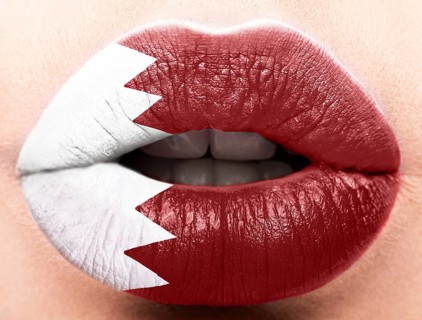Female lips close up with a picture of the flag of Katar. Red and white
