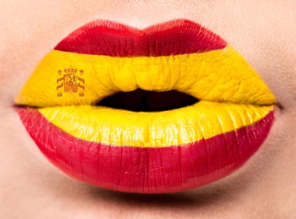 Female lips close up with a picture of the flag of Spain. red