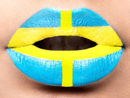 Female lips close up with a picture of the flag of Sweden. blue