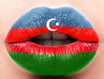 Female lips close up with a picture of the flag of Azerbaijan. Blue