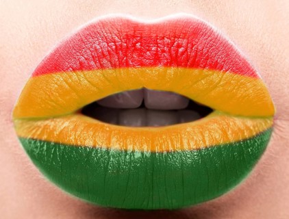 Female lips close up with a picture of the flag of Bolivia. Yellow