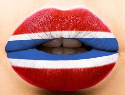 Female lips close up with a picture of the flag of Latvia. white