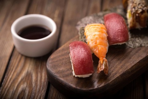 Sushi set on a wooden tray. Photo shot in studio