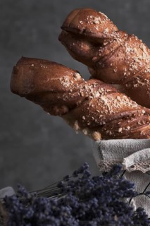White bread in a basket and lavender flowers in vintage style