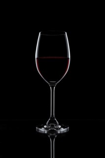 Red wine in a glass isolated on black background