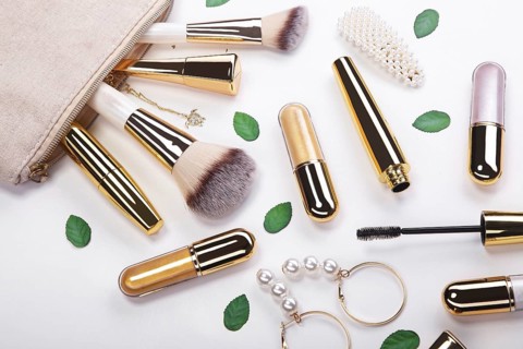 Set of brushes and cosmetic products in a cosmetic bag on a white background