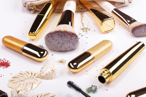 Set of brushes and cosmetic products in a cosmetic bag on a white background