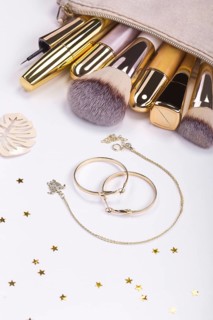 Set of brushes and cosmetic products in a cosmetic bag on a white background