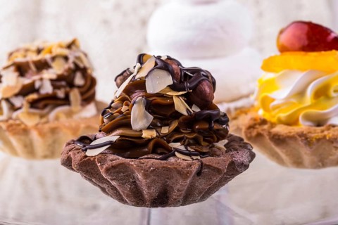 Tasty cakes on a transparent plate on a background of a white tablecloth