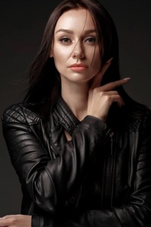 Daring girl model in black leather dress