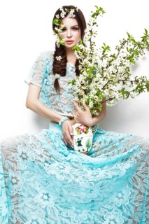 Beautiful brunette girl in blue summer dress with a gentle romantic make-up