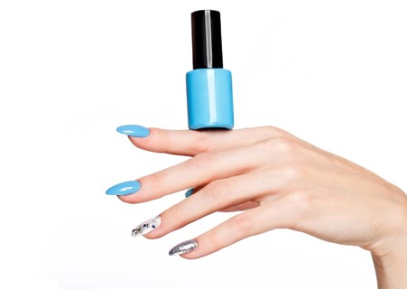 Beautiful summer blue manicure on female hand with nail polish. Close-up. Picture taken in the studio