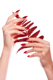 Bright festive red manicure on female hands. Nails design