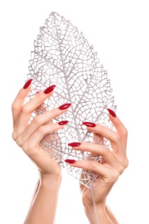 Bright festive red manicure on female hands. Nails design