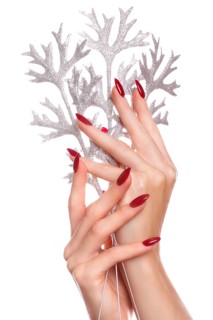 Bright festive red manicure on female hands. Nails design
