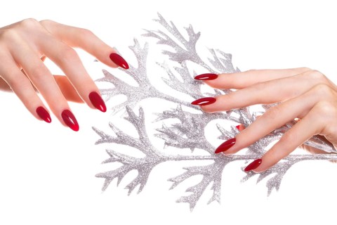 Bright festive red manicure on female hands. Nails design