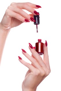 Bright festive red manicure on female hands. Nails design