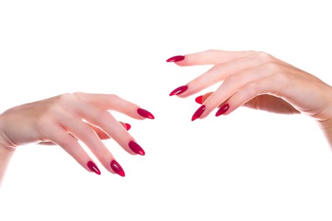 Bright festive red manicure on female hands. Nails design
