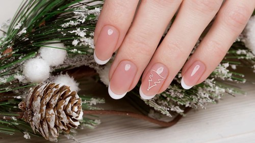 Snow White manicure on female hands. Winter nail design. Picture taken in the studio on a background of wool